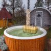 Hot tub in setting with barrel and grill Hot tub in setting with barrel and grill